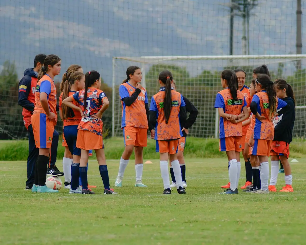 High school girls celebrating after a Powderpuff football game with team spirit and confidence