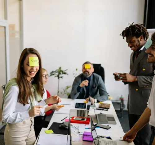 Coworkers playing fun team-building games and laughing together